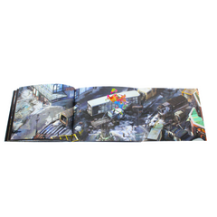 Open book displaying aerial urban scenes across a two-page spread.
