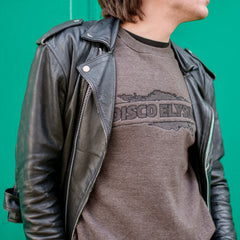 Black leather jacket worn over a gray t-shirt with ’DISCO FLY’ text.