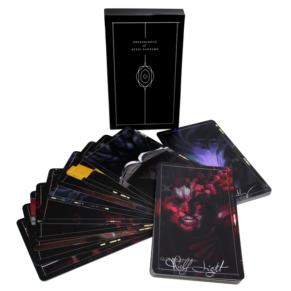 Deck of dark-themed tarot or oracle cards with artistic imagery spread out from its box.