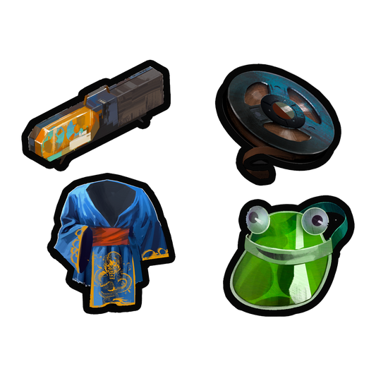Four cartoon-style stickers or patches depicting various objects: a futuristic device, a steering wheel, a blue robe or garment, and a frog face.