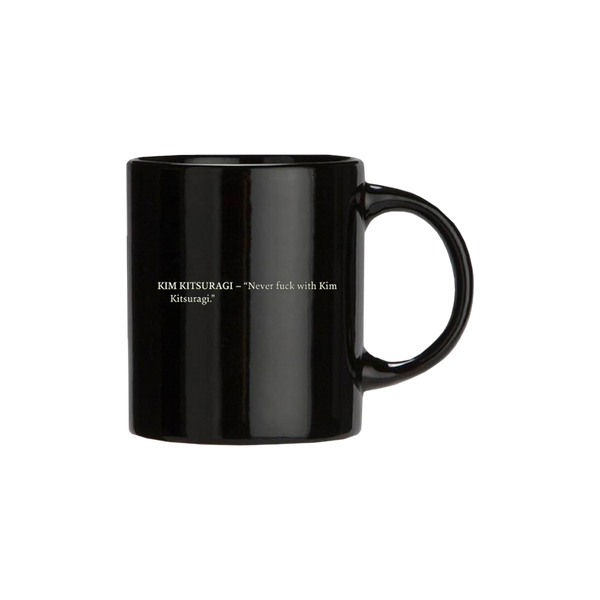 Black ceramic mug with white text printed on its side.