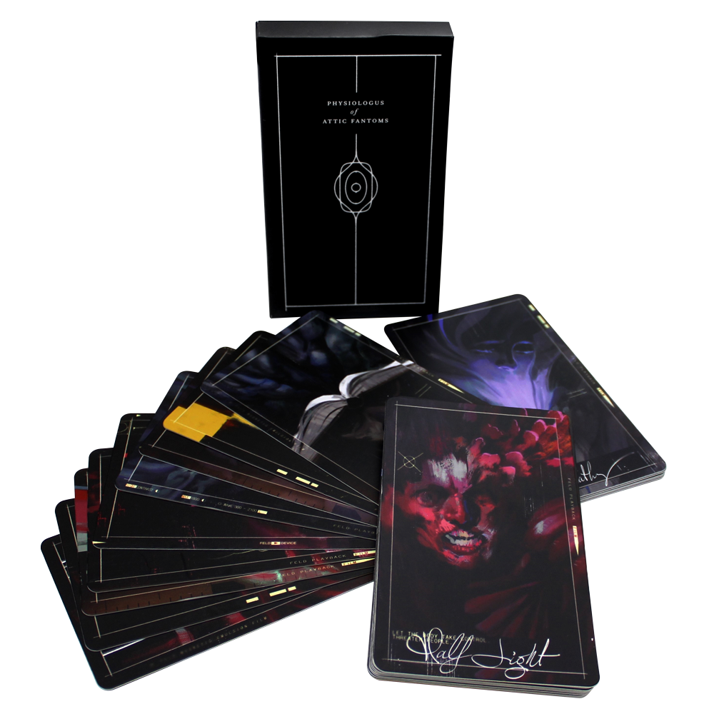 Deck of dark-themed tarot or oracle cards with artistic imagery spread out from its box.