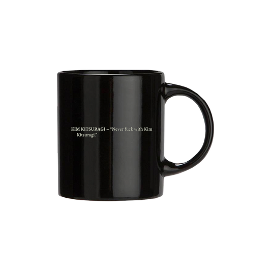Black ceramic mug with white text printed on its side.